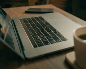 macbook pro on brown wooden table