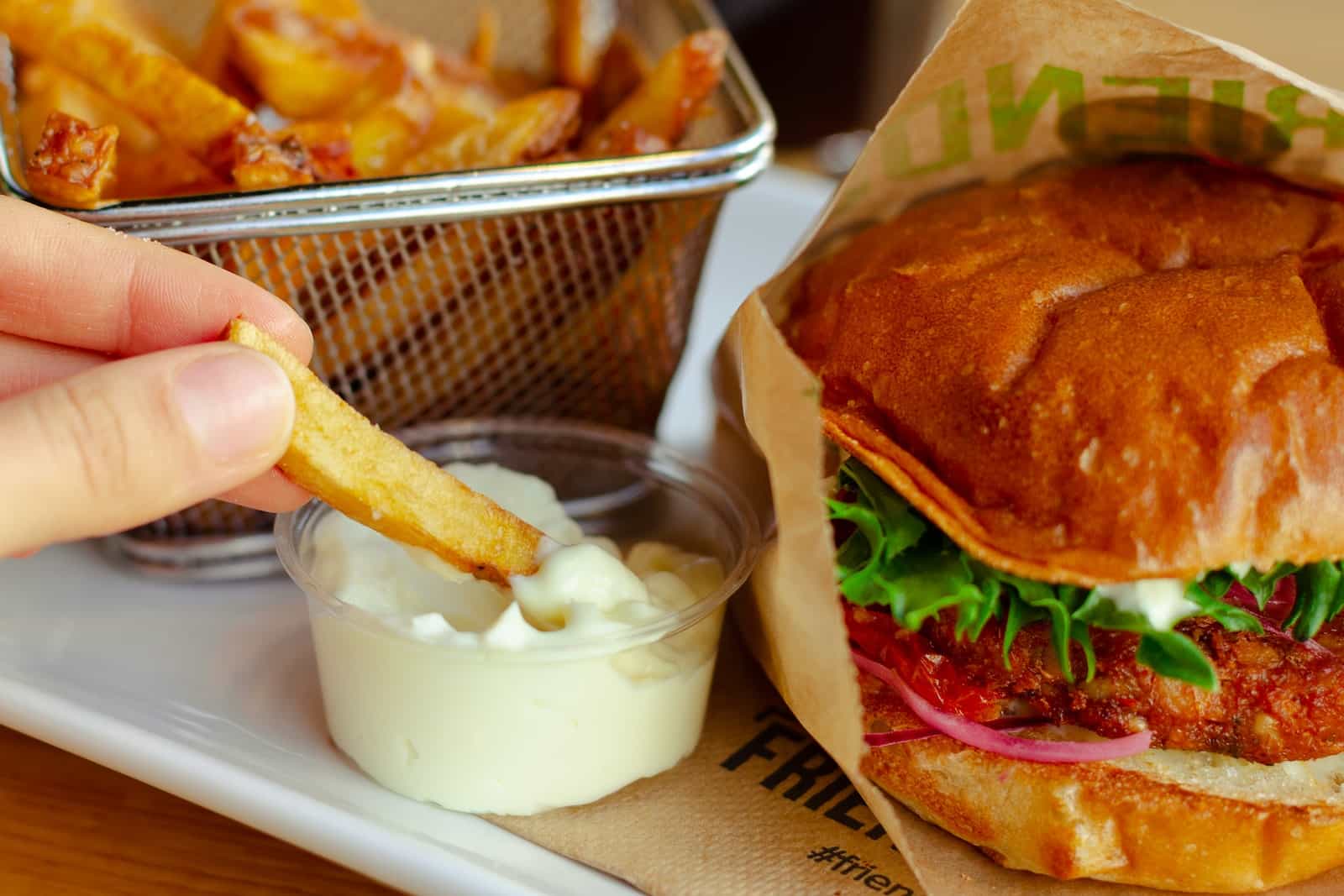 burger with cheese and vegetable on stainless steel tray